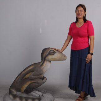 Juvenile Theropod Sitting Dinosaur Statue